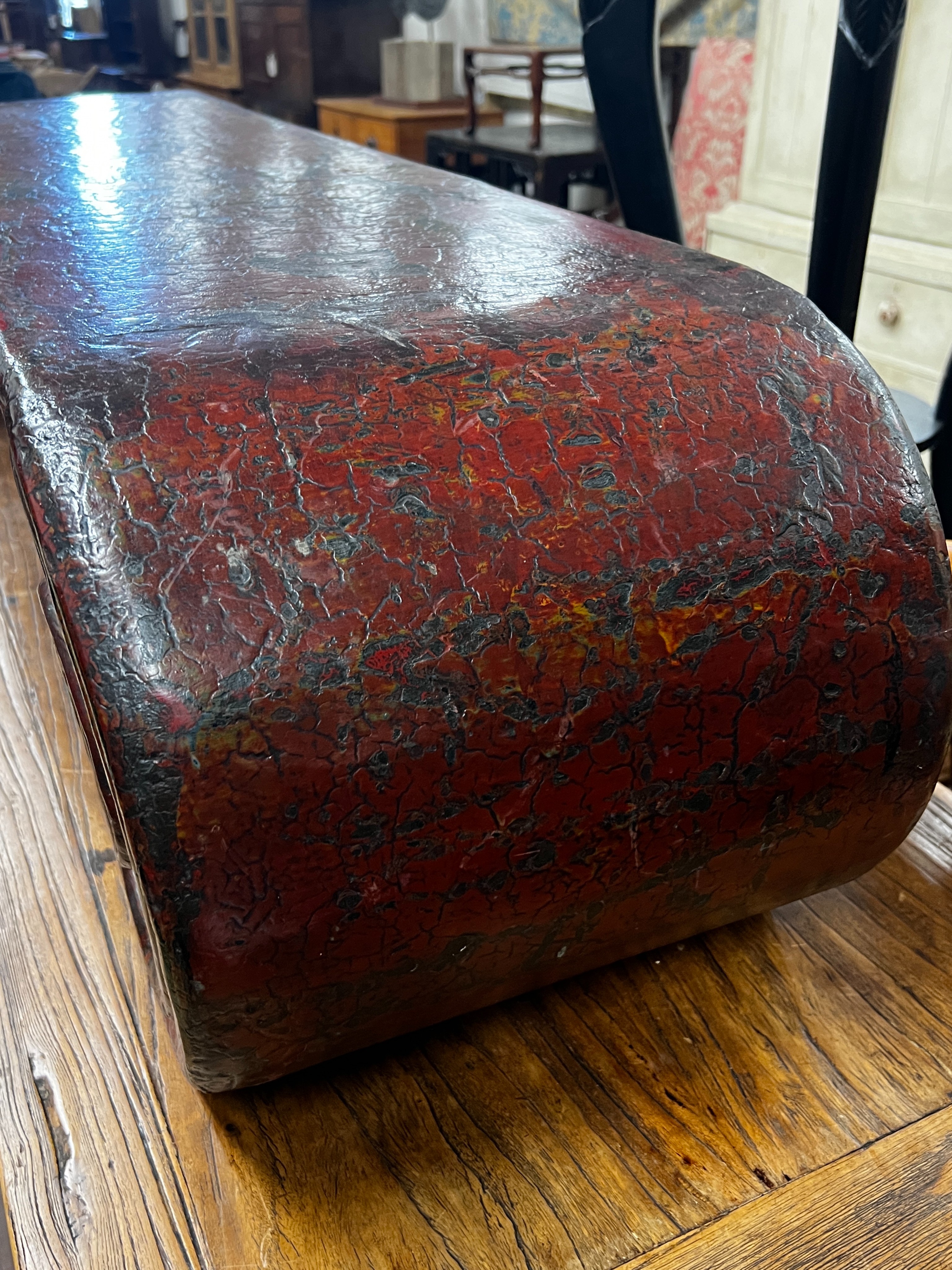 A Chinese lacquer scroll end low table, width 146cm, depth 35cm, height 33cm